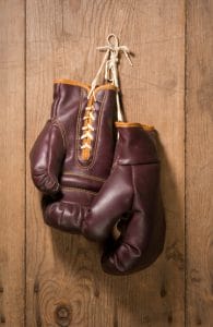 Boxing Gloves hanging against an old wood wall